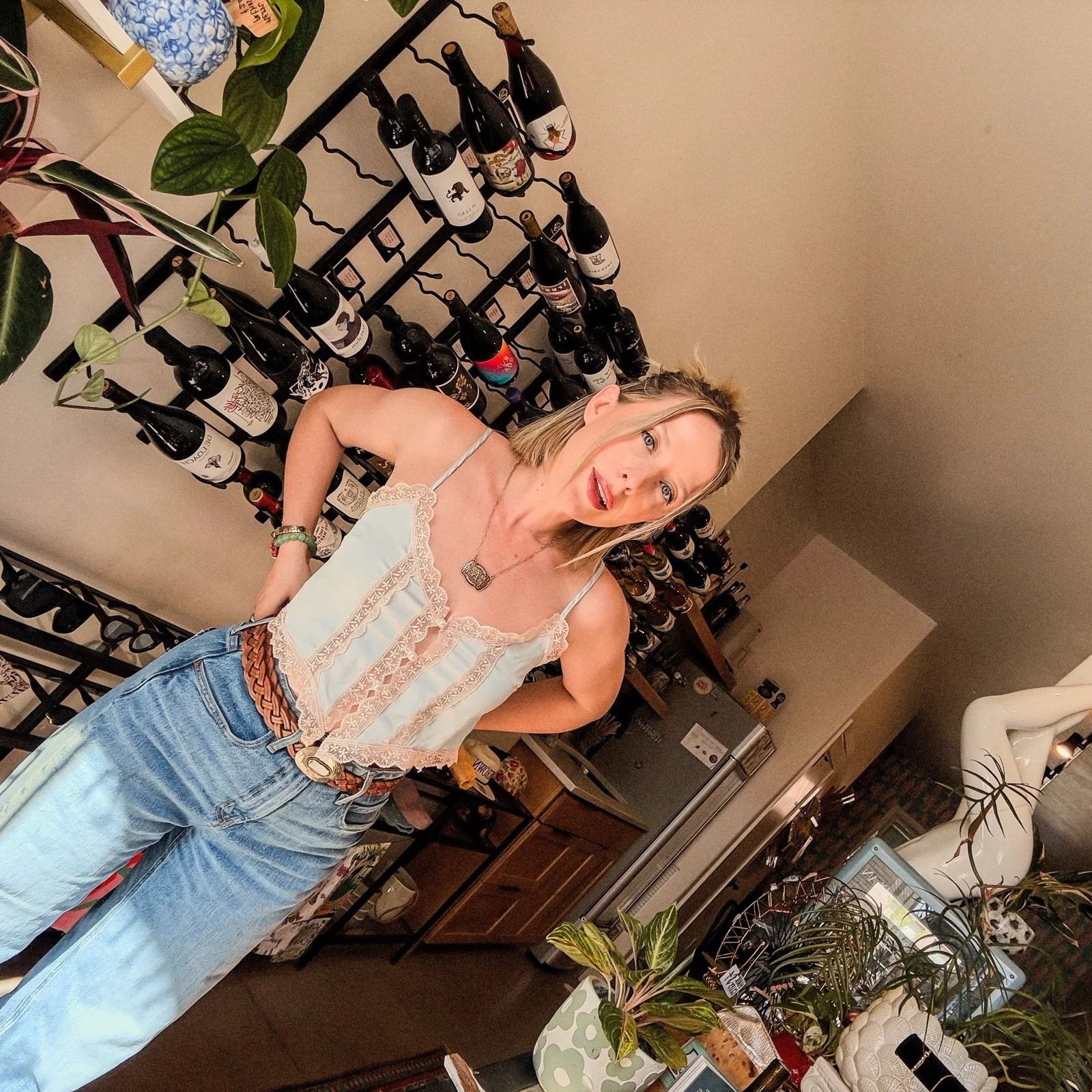 Amber posing in the Thrown shop with wine bottles and boutique decor